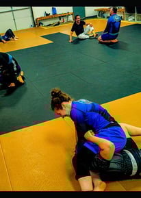 Ice Dragon Academy team members enjoying a No-Gi BJJ rolling session in a positive training environm