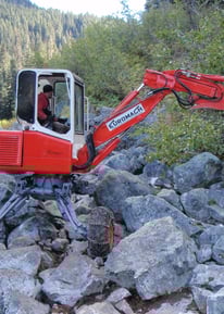 Compact spider hoe being used to construct trail into Joffre Lakes Park