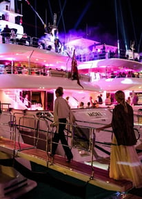 a group of people standing on a boat in the water