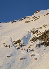 a group of people walking up a snowy mountain - Huayna Potosi in Bolivia