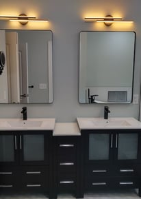a bathroom with two sinks and mirrors