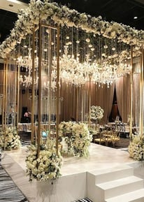 Luxury wedding hall decor with chandeliers and floral centerpieces by Amika Weddings in Pune.