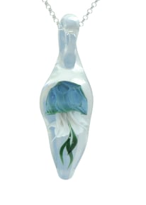 a blue jellyfish inside a clear glass pendant
