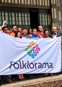 a group of people standing in front of a banner