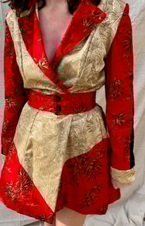 The front of red cotton, black lace, and gold butterfly coat