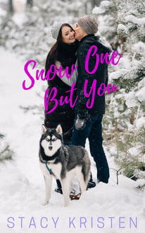 A man and woman kissing in the snow with a husky in a leash.