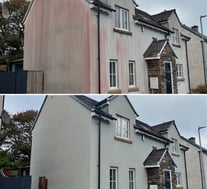Render cleaning on a house in Lincoln using soft washing and chemical treatment to remove stains