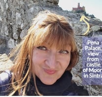 Alonga Travel the author admires the view of Pena Palace in Sintra, Portugal from Castle of Moors