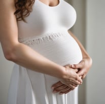 a black and white photo of a pregnant woman