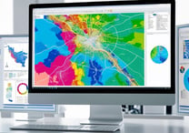 A map on a center monitor with two panels beside it, showing data.