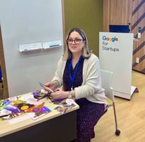 Julie Gachet Mitrovic sitting at a table with Strengths cards for a workshop at Google for Startups