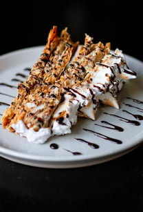 a dessert with chocolate and cream on a plate