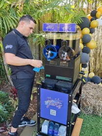 Kahn setting up the slushie machine for Rebecca's 21st in Wakerley.