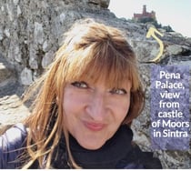 Alonga Travel the author enjoying the view of Pena Palace in Sintra, Portugal from the Castle of Moors