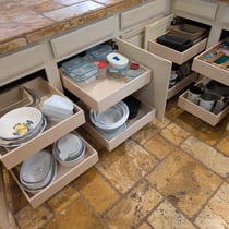 Kitchen cabinet pull-out shelves extended for easy access to contents.