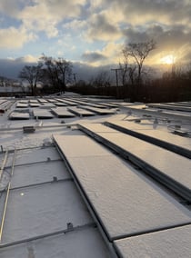 fully installed solar panels on roof with snow