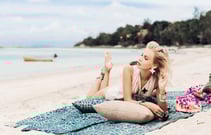 A fashionable woman posing on a beach during a lifestyle photoshoot for a jewelry brand on Koh Samui
