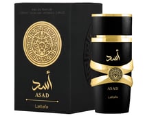 a black and gold perfume with a black box