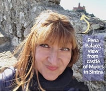 Alonga Travel the author enjoying the view of Pena Palace in Sintra, Portugal from the Castle of Moors