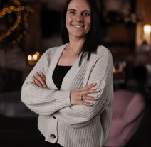 a woman in a white sweater and black pants