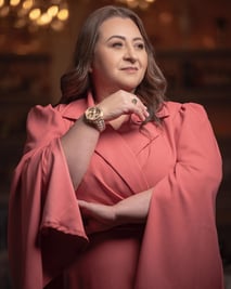 a woman in a pink dress with a watch on her wrist