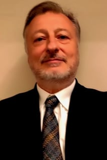 Alberto Barbieri in a suit and tie with a tie