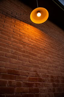 brick wall with names and a lamp in Tucson Arizona