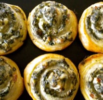 a bunch of rolls of spinach pin wheels
