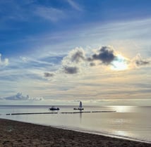 a boat near the beach in the sunset - symbolizing direction and transformation