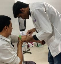 a nurse taking a patient's blood