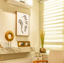 a living room with a clock and a clim on the wall