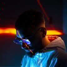 a man in a blue jacket and sunglasses