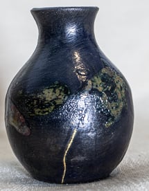 Raku-fired vessel with Kintsugi, made in Amman, Jordan, dark glaze with golden lines of repair