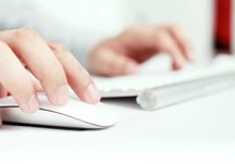 Hands operating a keyboard and mouse