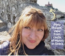 Alonga Travel the author admires the view of Pena Palace in Sintra, Portugal from Castle of Moors