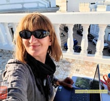 Alonga Travel the author works on her laptop from a rooftop terrace in Portugal