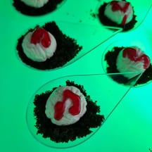 SweetAz Co. LED glow serving tray with individual Halloween-themed treats of brain cheesecake on Oreo cookie dirt.
