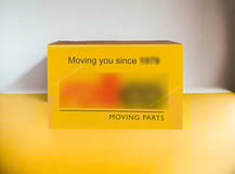 Corrugated folding carton for moving parts