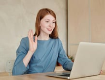 a woman sitting at a table with a laptop and attending customers of fix collision for insurance help