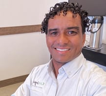 a man in a white shirt and a coffee maker