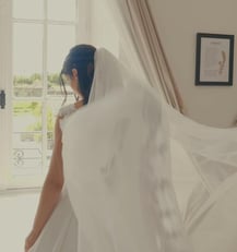 Instant capté par la vidéaste : la mariée de dos ajuste son voile avant la cérémonie