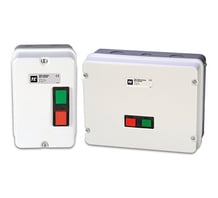 a white and green switch box with a red and green button