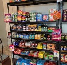 a shelf of food and snacks on a shelf