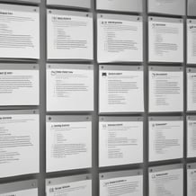 A close-up of a smartphone screen displaying a variety of applications, arranged in a grid pattern. The apps have distinct icons and include names like Agenda, TickTick, and Udemy. The background is blurred, highlighting the focus on the phone's display.