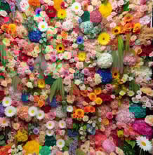 a large flower arrangement of flowers in a display
