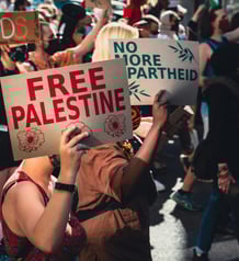 a group of people holding signs that read free palestine