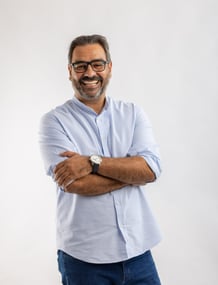 a man with glasses and a watch on his wrist