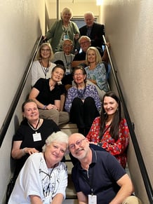 twelve Telelaget members sit in a stairwell