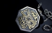 a silver and gold necklace with a MONEY sign