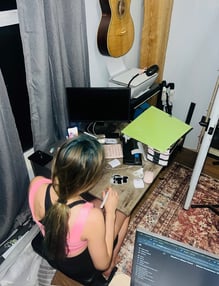 Baylor hand making stickers for her shop